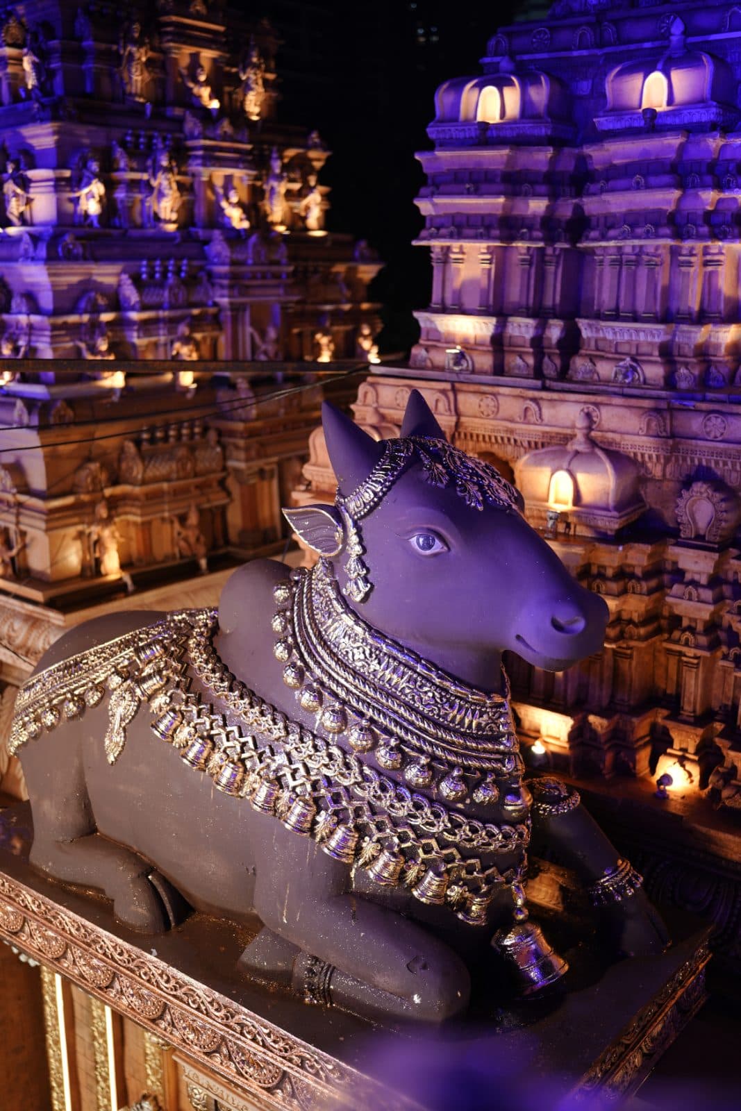 Ornamented Nandi sculpture set against temple architecture