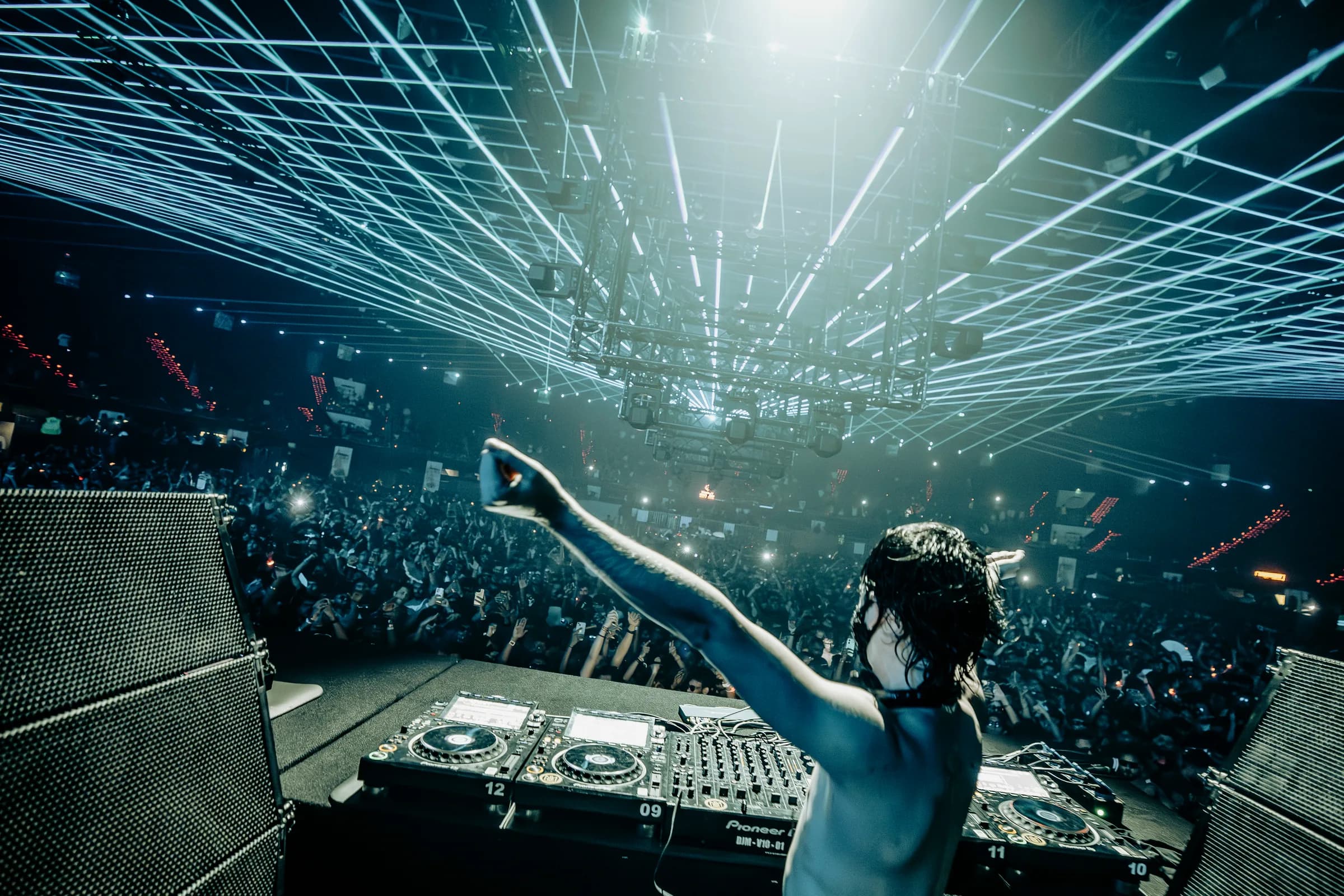 Circus Festival DJ framed by converging laser light