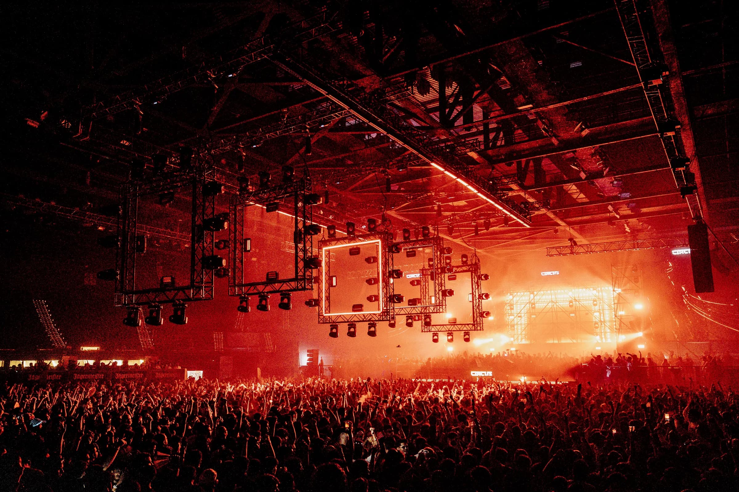 Crowd facing the red Circus Festival stage