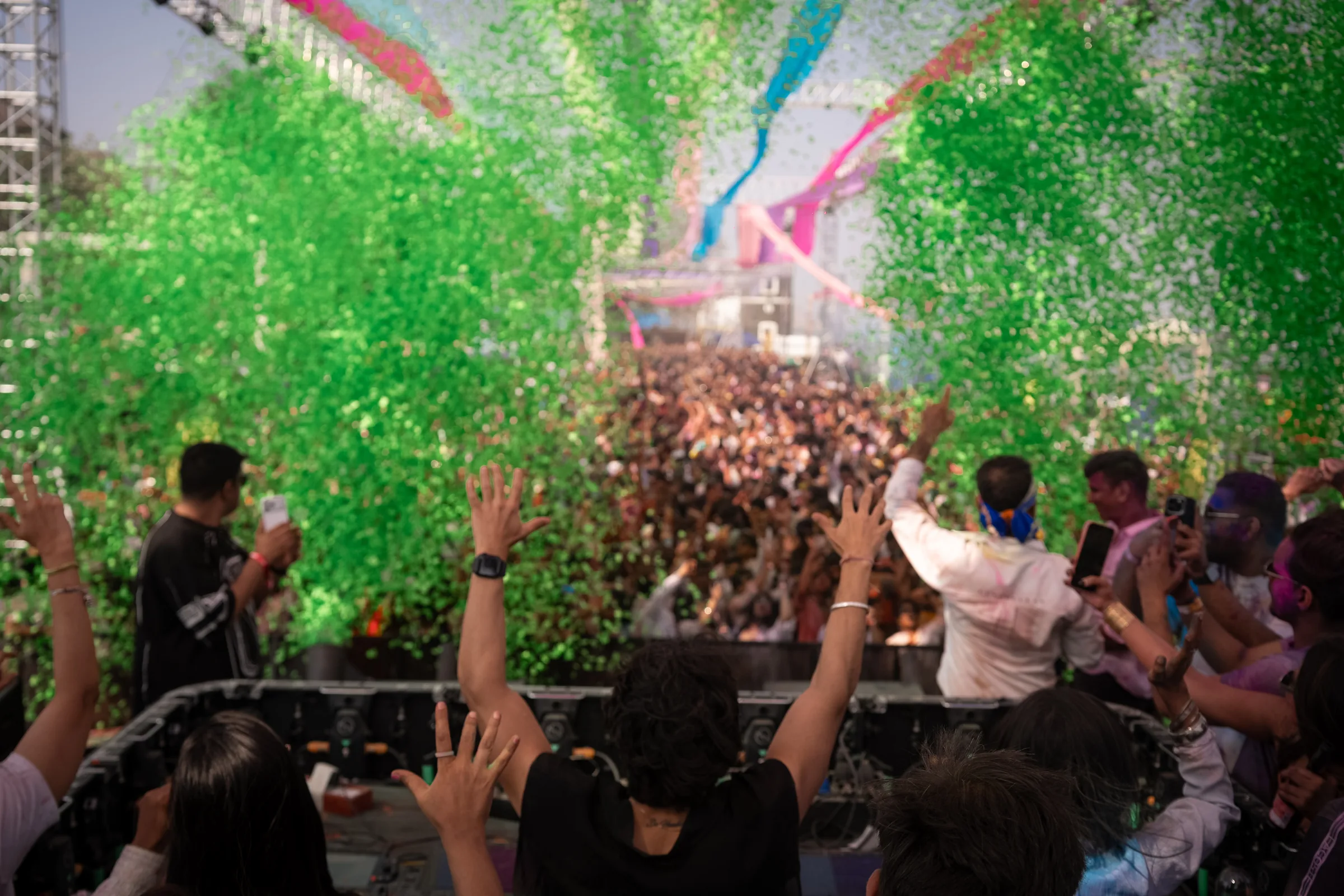 Holi at the Bay crowd celebrating beneath a cloud of green colour
