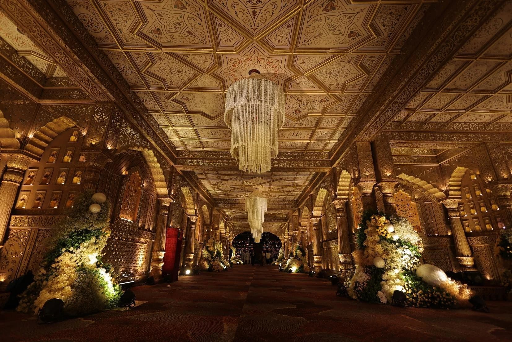 A warmly lit passage with intricate wedding set details