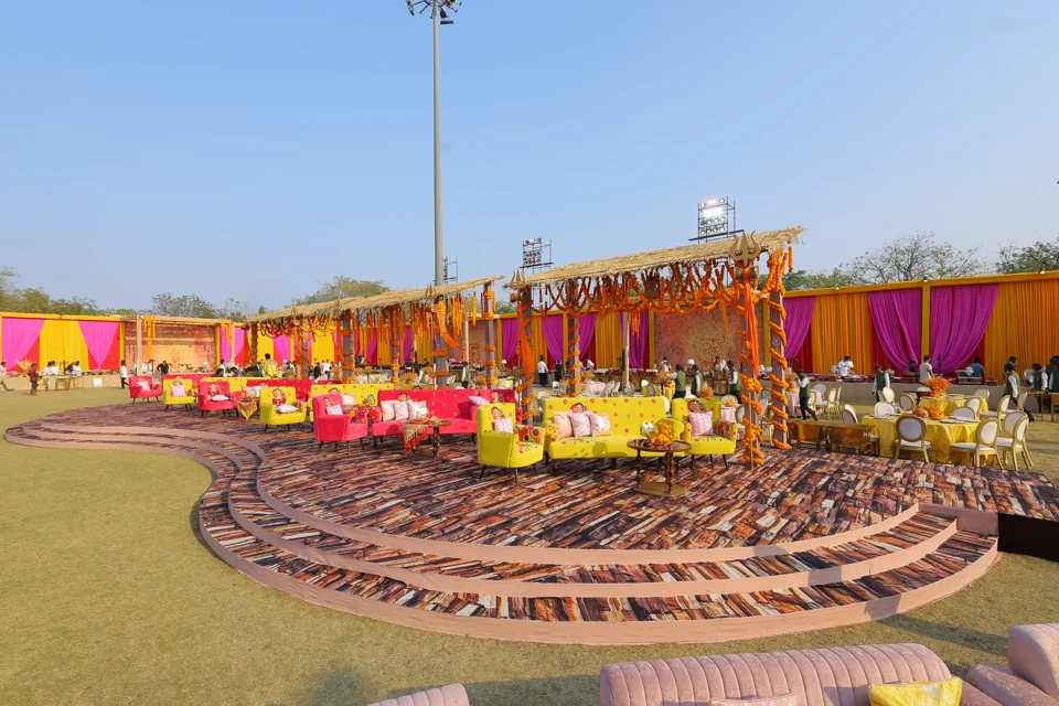 A colourful open-air haldi lounge arranged in sweeping circles