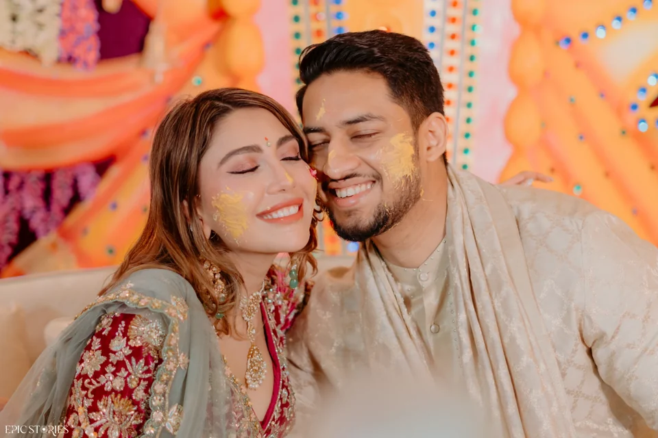 A couple sharing a joyful moment during their haldi celebration